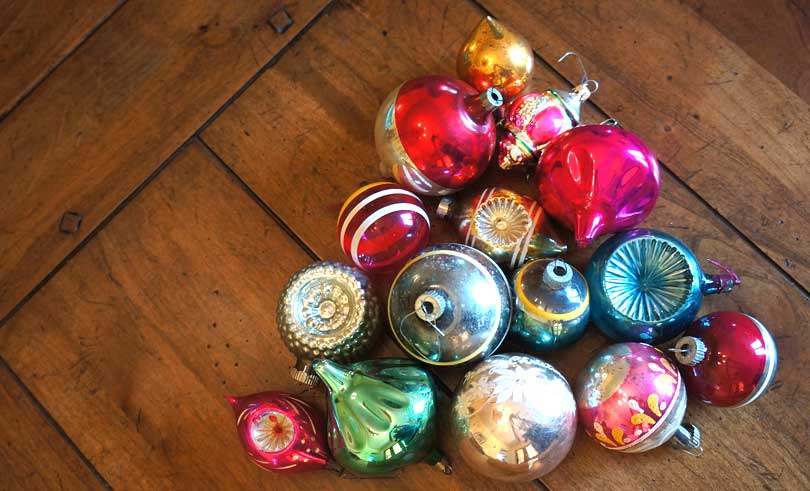 vintage Christmas ornaments laid out on a table