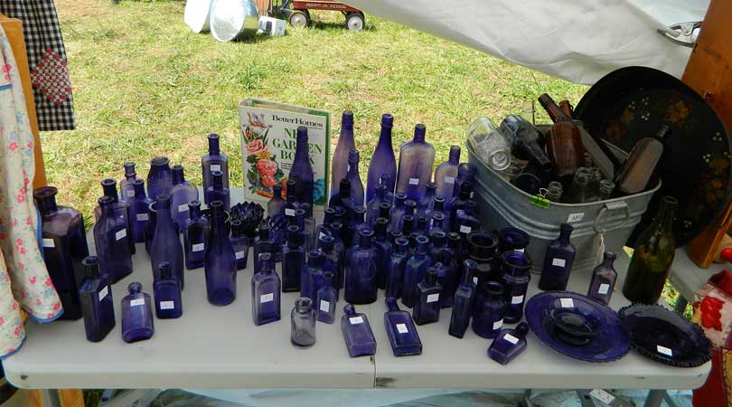 vintage blue bottles at yard sale