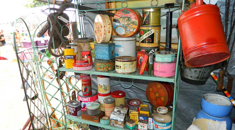 vintage tins on a shelf at a garage sale
