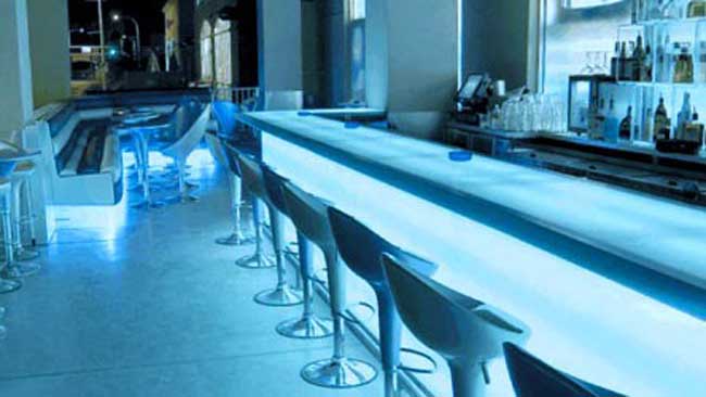 white bar illuminated with blue accent lighting