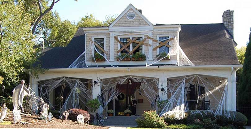 haunted house covered in cobwebs and boarded up