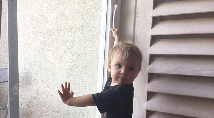 toddler grabbing sliding door handle