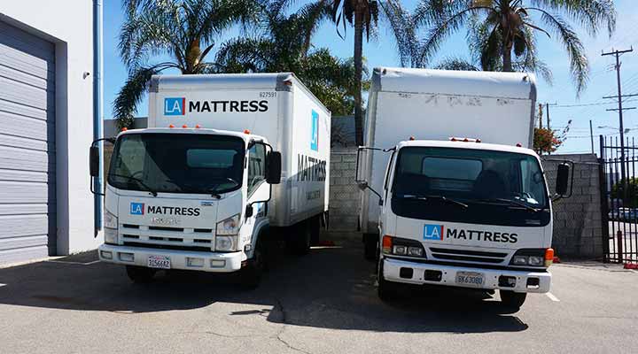 two mattress movers trucks parked