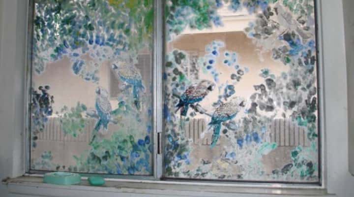 view of painted birds on windows in a fixer upper house
