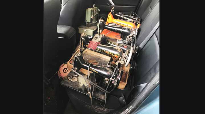 vintage sewing machines in the backseat of a car