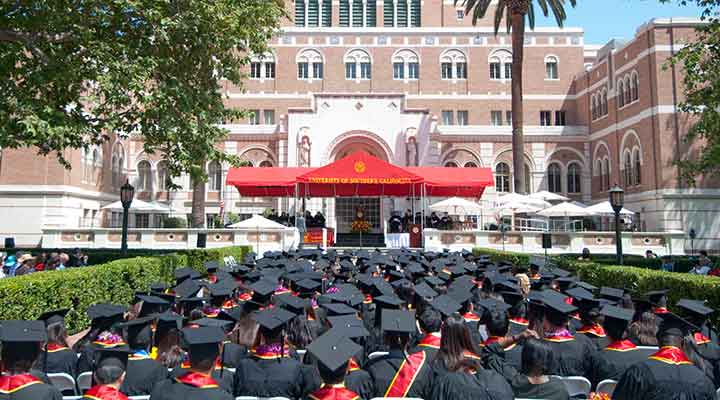 USC students in cap and gowns sitting on commencement day ceremony