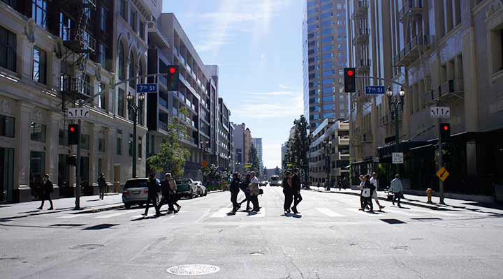 people crossing street on a sunny downtown los angeles day