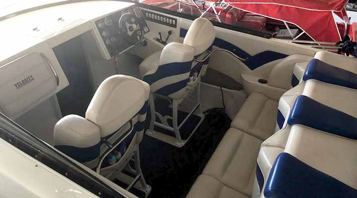blue and white seating cabin of power boat in storage