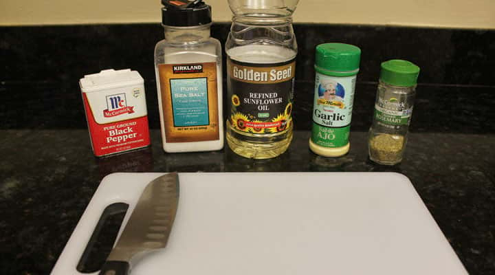 kitchen workspace with spices organized along white cutting board