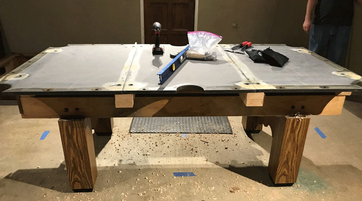 slate sections and tools on deconstructed pool table