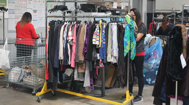 Goodwill Los Angeles workers prepping clothing racks