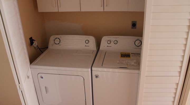 washer and dryer in hallway laundry room