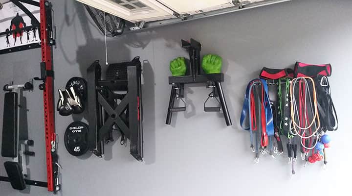 organized fitness bands hang on wall of garage home gym